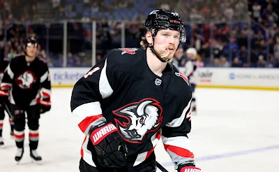 Buffalo Sabres forward Bowen Byram reacts after scoring goal in 2025 game.